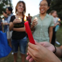 Students and community members hold candles as they attend a solidarity vigil to stand against white supremacy and racism hosted by BYU college Republican and Democrat clubs in Provo on Sunday, Aug. 20, 2017.