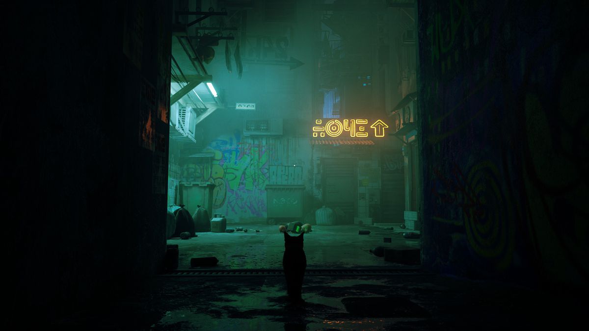 the protagonist cat of Stray standing in a shadowy alley looking at a wall with a neon sign on it