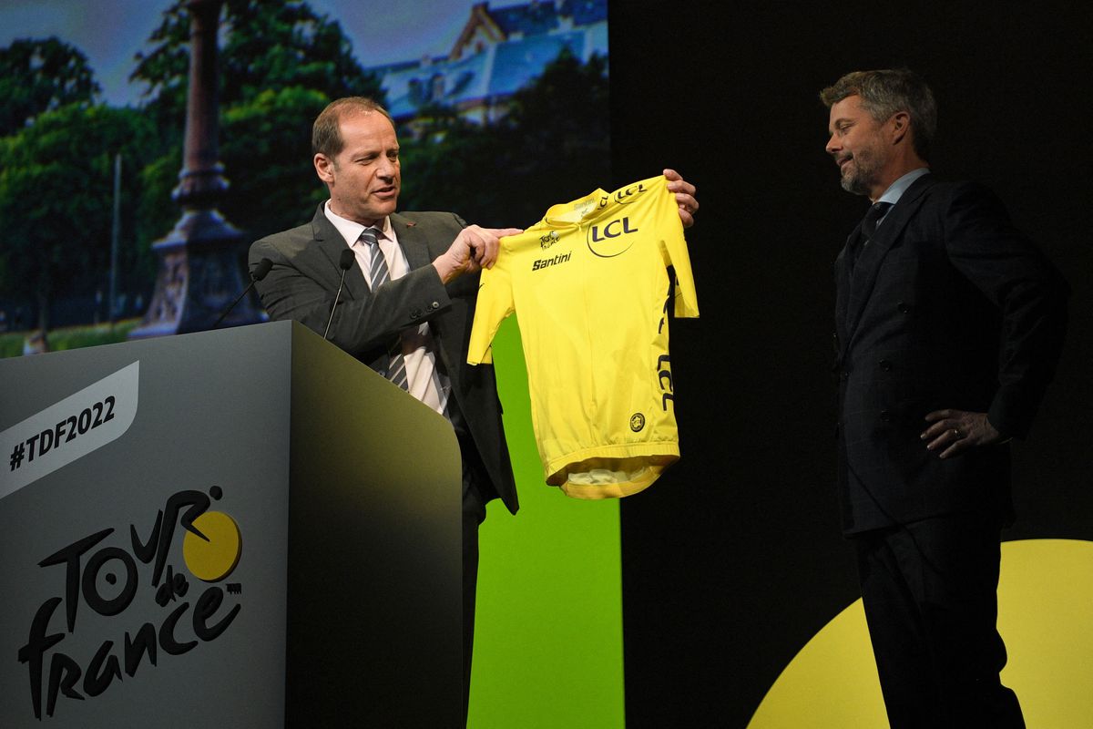 Prince Frederik of Denmark receives a yellow jersey from Tour de France director Christian Prudhomme during the official presentation of the 2022 Tour de France cycling race, in Paris, on October 14, 2021.