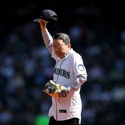 SEATTLE, WASHINGTON - AUGUST 28: Hisao Inagaki, consul general of Japan in Seattle, acknowledges the crowd after throwing out the ceremonial first pitch before the game between the Seattle Mariners and the Cleveland Guardians at T-Mobile Park on August 28, 2022 in Seattle, Washington.