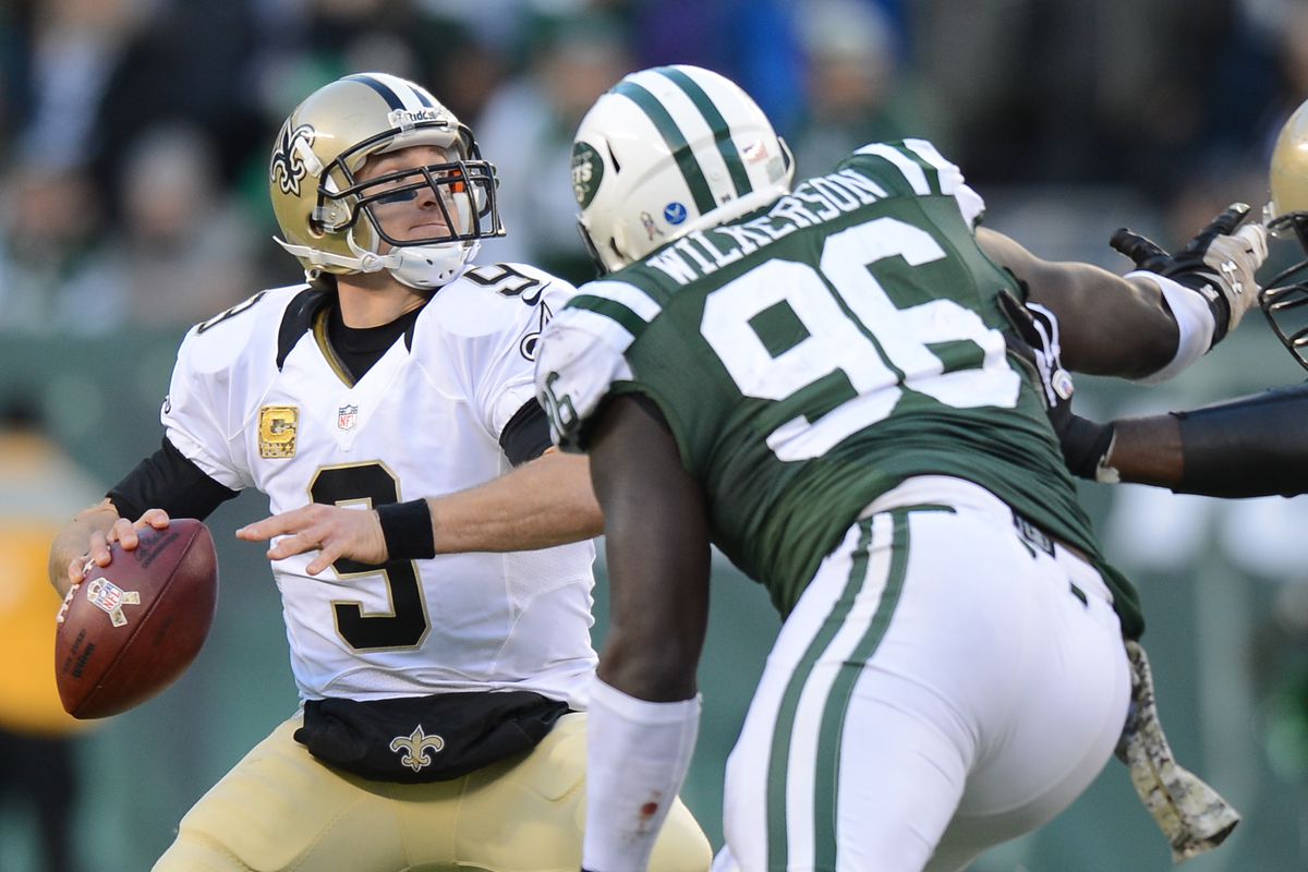 EAST RUTHERFORD, NJ: Quarterback Drew Brees (9) of the New Orleans Saints is put under pressure from defensive end Muhammad Wilkerson (96) of the New York Jets during a games at MetLife Stadium.