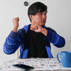 Afghan refugee Wali Kakaie gestures at his house in North Salt Lake on Tuesday, Nov. 23, 2021, as he describes his journey out of the airport in Kabul, Afghanistan.