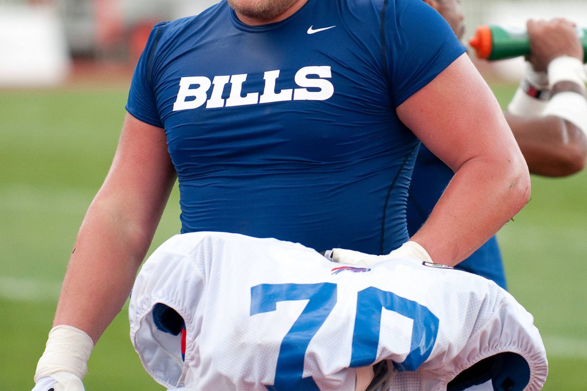 August 13, 2012; Pittsford, NY, USA; Buffalo Bills center Eric Wood (70) leaves the field after a training camp session at St. John Fisher College.  Mandatory Credit: Mark Konezny-US PRESSWIRE