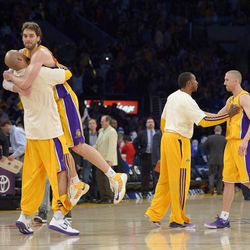 Los Angeles Lakers forward Pau Gasoll, of Spain,, second from right, jumps into the arms of Robert Sacre, as guard Steve Blake is congratulated by Chris Duhon after they defeated the Golden State Warriors in their NBA basketball game, Friday, April 12, 2013, in Los Angeles. The Lakers won 118-116. (AP Photo/Mark J. Terrill)