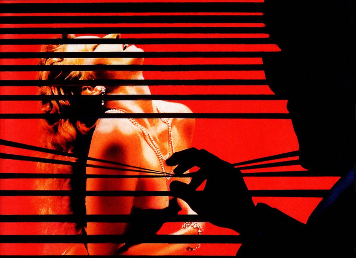Photo detail from the DVD cover for the Twilight Time edition Brian De Palma’s Body Double, with a silhouetted man peeking through shades at a scantily clad woman clutching her breasts