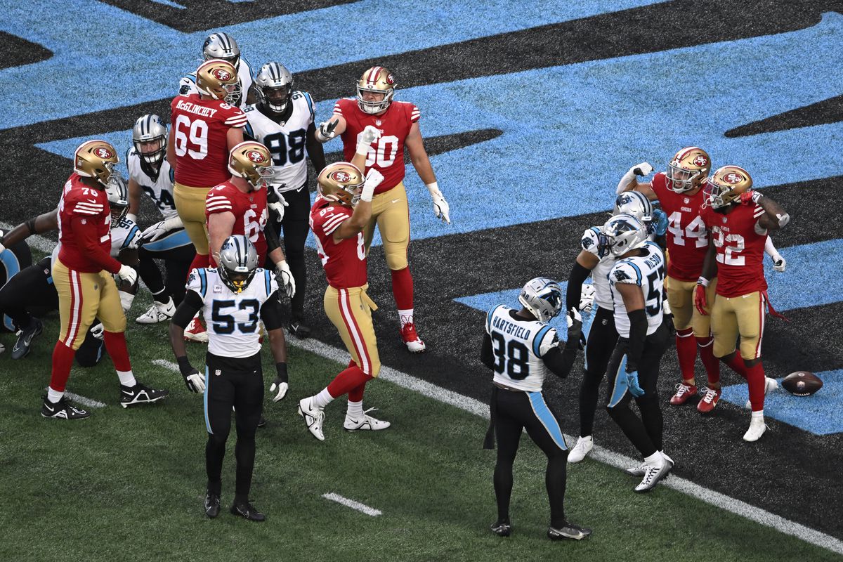 Jeff Wilson Jr. #22 of the San Francisco 49ers celebrates his touchdown with Kyle Juszczyk #44 during the fourth quarter against the Carolina Panthers at Bank of America Stadium on October 09, 2022 in Charlotte, North Carolina.