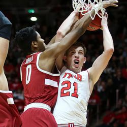Stanford Cardinal forward Kezie Okpala (0) is charged with a foul as Utah Utes forward Tyler Rawson (21) goes to the hoop at the Huntsman Center in Salt Lake City on Thursday, Feb. 8, 2018.