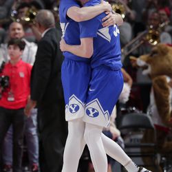 BYU guard Evan Troy, left, hugs guard TJ Haws after Haws’ last-second basket against Houston during an NCAA college basketball game Friday, Nov. 15, 2019, in Houston. BYU won 72-71. 