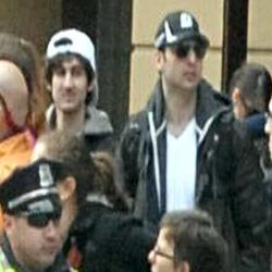 This photo released by the FBI early Friday April 19, 2013, shows what the FBI is calling the suspects together,  walking through the crowd in Boston on Monday, April 15, 2013, before the explosions at the Boston Marathon. Tamerlan Tsarnaev, 26, is on the right.