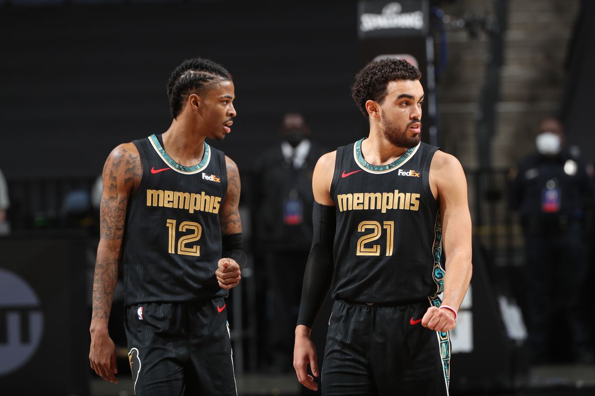 Ja Morant and Tyus Jones of the Memphis Grizzlies looks on during the game against the Phoenix Suns on January 18, 2021 at FedExForum in Memphis, Tennessee.