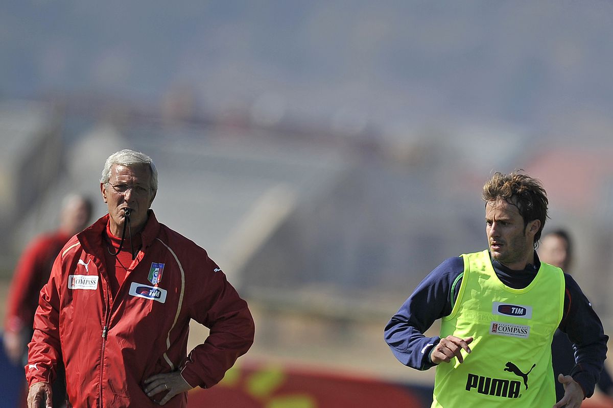 Italy’s coach Marcello Lippi (L) follows