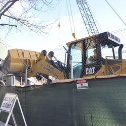 Tight working quarters on Waveland. This front loader is brushing right up next to the fence. 