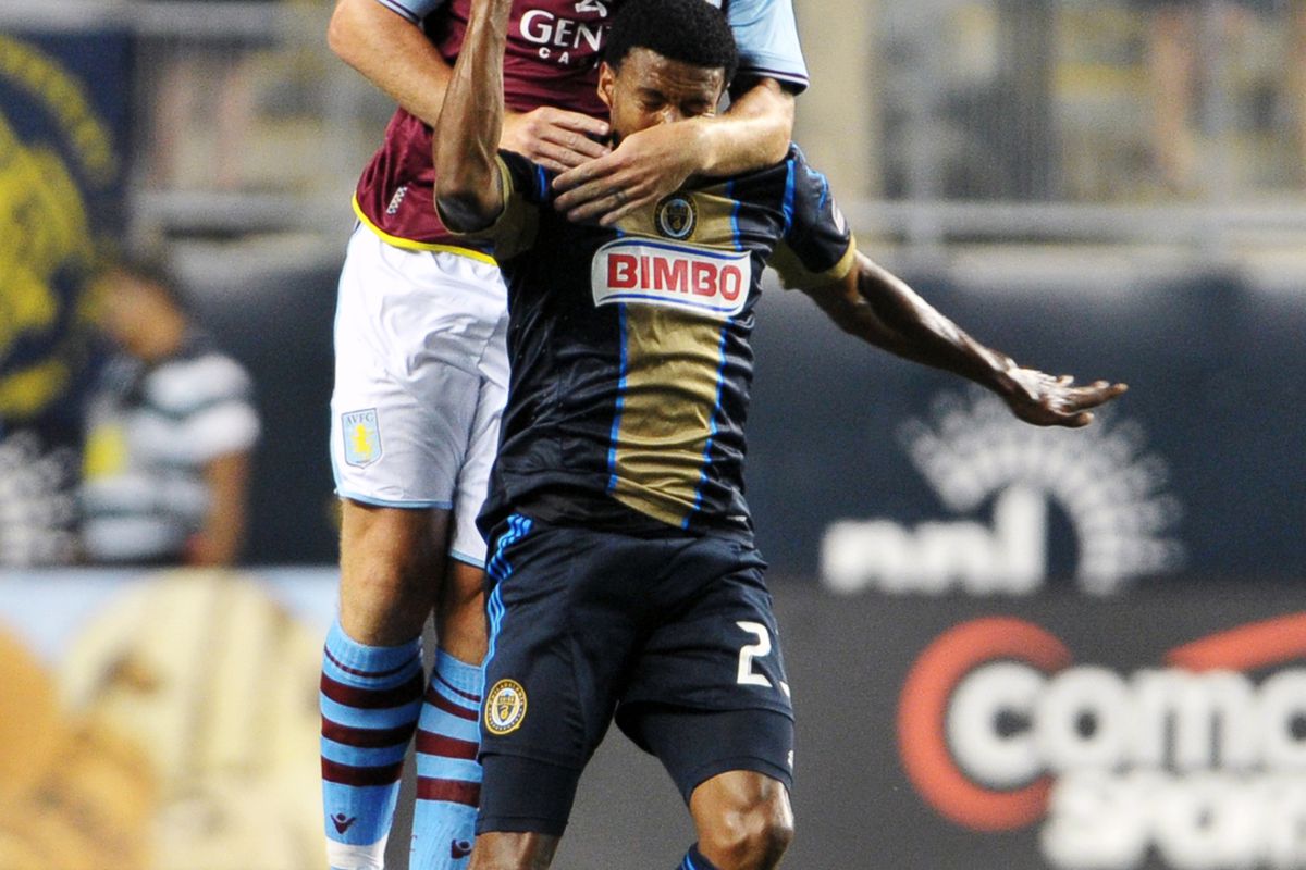 CHESTER, PA - JULY 18: Richard Dunne #5 of Aston Villa goes over the top of Lionard Pajoy #23 of the Philadelphia Union at PPL Park on July 18, 2012 in Chester, Pennsylvania. Aston Villa won 1-0. (Photo by Drew Hallowell/Getty Images)
