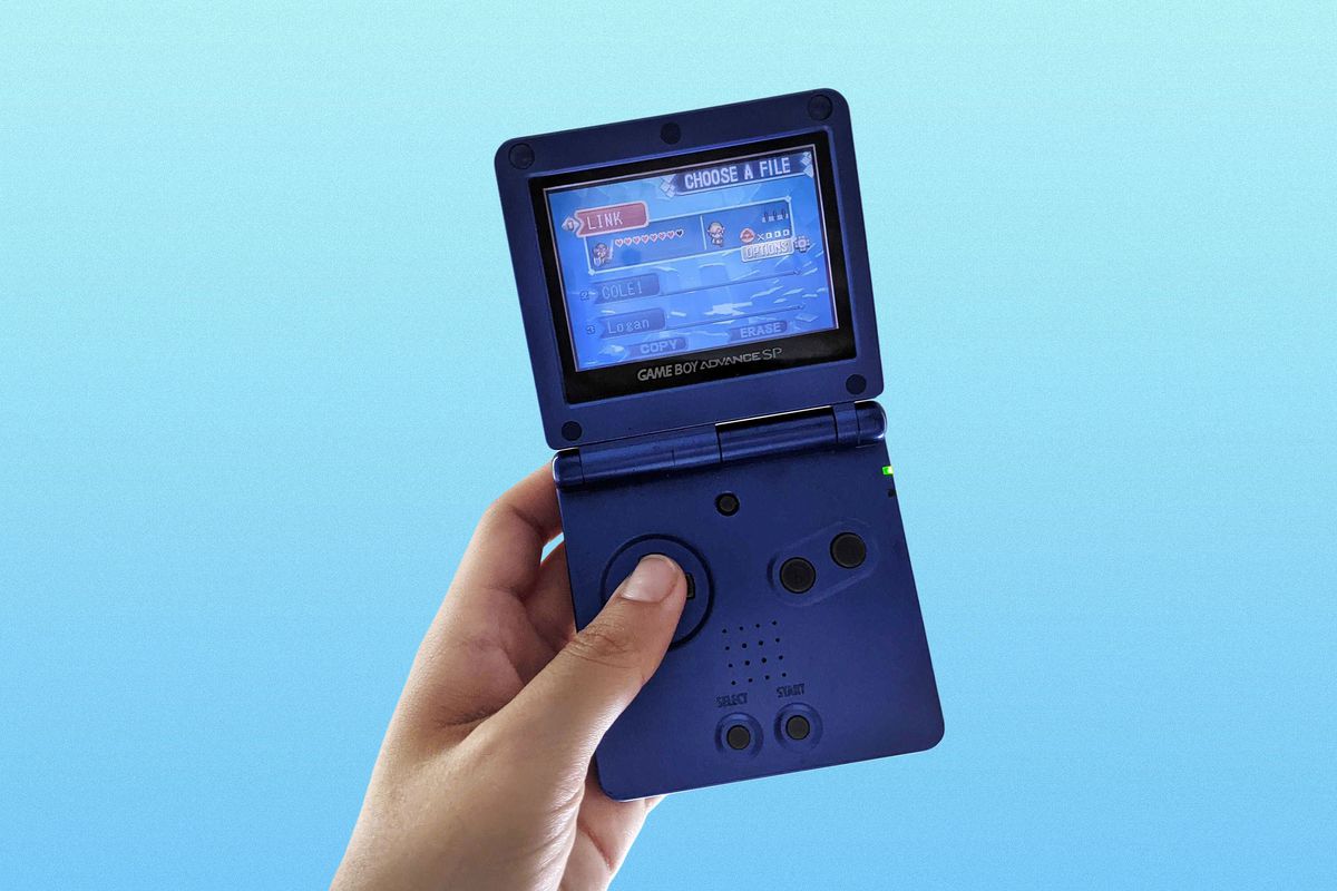 Hand holding a blue Game Boy Advance