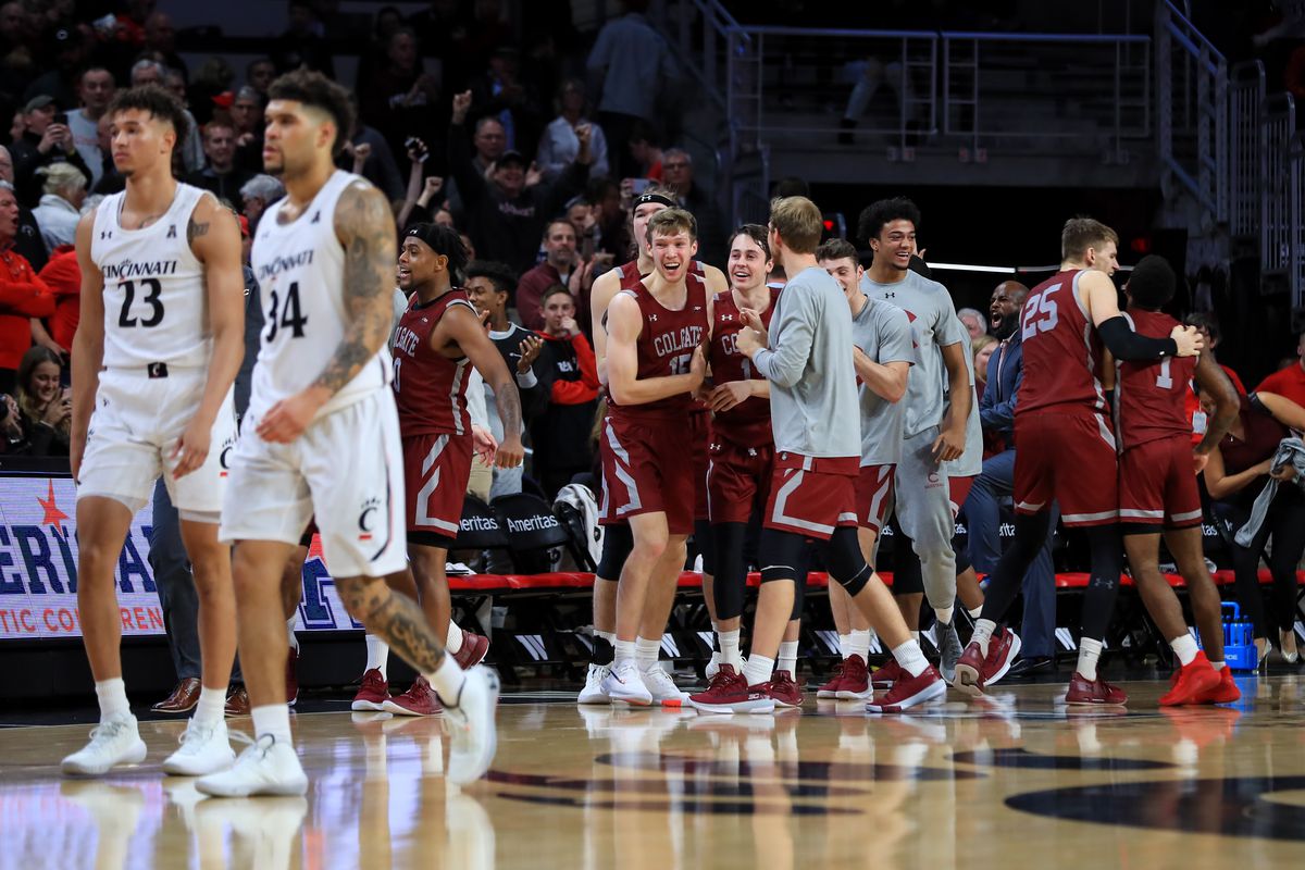 Members of the Colgate Raiders celebrate together at the bench after defeating the Cincinnati Bearcats at Fifth Third Arena.