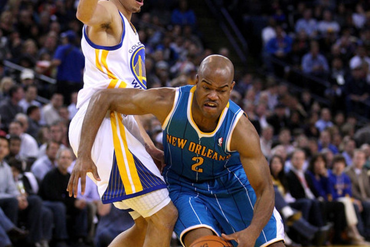 OAKLAND CA - JANUARY 26: Jarrett Jack #2 of the New Orleans Hornets dribbles around Stephen Curry #30 of the Golden State Warriors at Oracle Arena on January 26 2011 in Oakland California.  <em>(Photo by Ezra Shaw/Getty Images)</em>