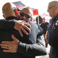 Jeff Brotherson, father of officer Cody Brotherson, hugs West Valley City Police Lt. Blair Barfuss, left, at a fundraiser and memorial car show and cruise at the Valley Fair Mall in West Valley City on Saturday, Nov. 12, 2016. The event was held in honor of Cody Brotherson, a West Valley City police officer who was killed in the line of duty.