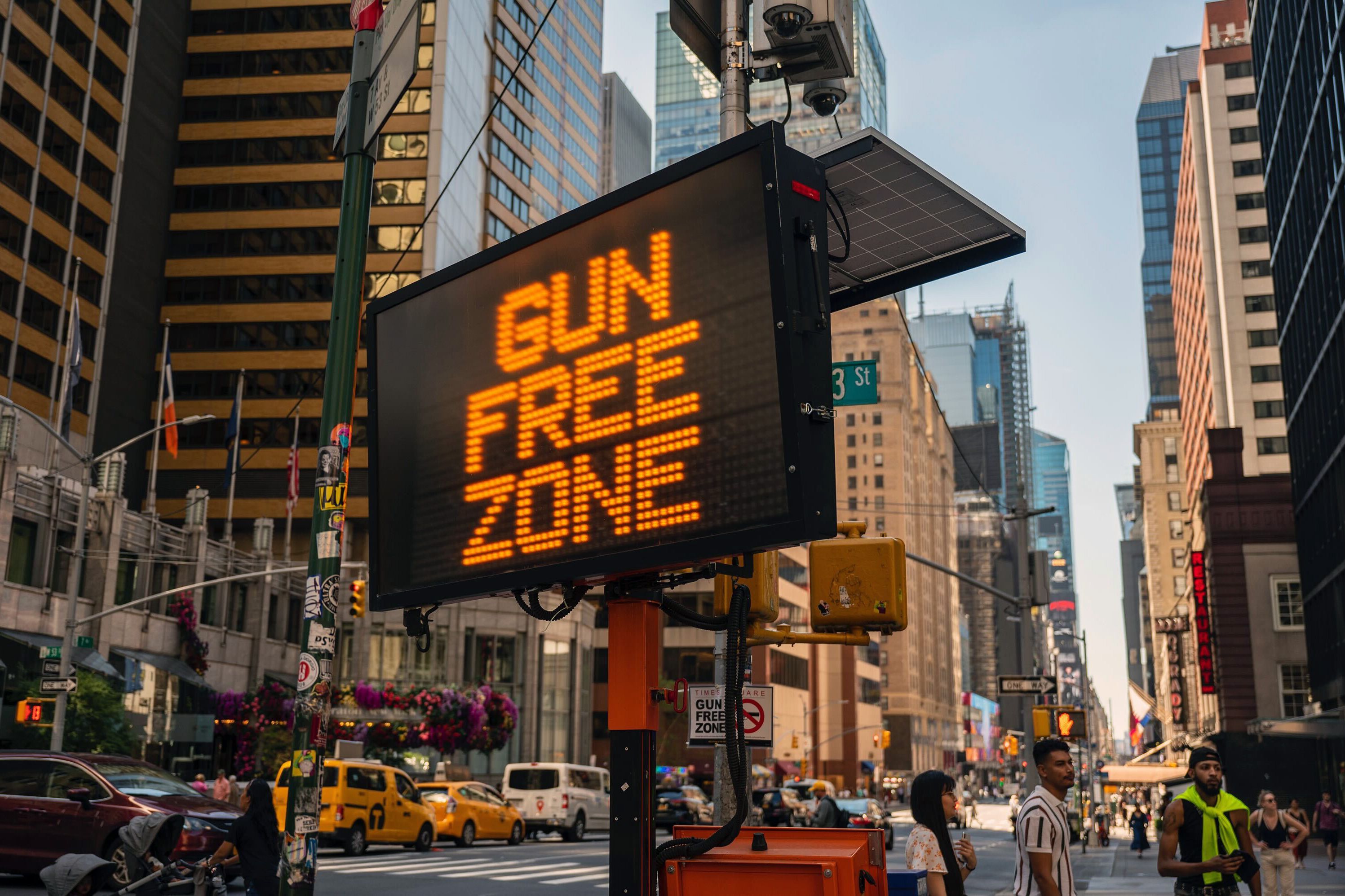 A large electronic traffic sign at the intersection of 7th Avenue and 53rd Street warns people about carrying weapons into the Times Square area, Sept. 2, 2022.