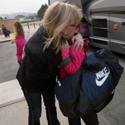 Lynette Baird pulls her daughter, Shayla, in for one more hug before Shayla leaves for after-school skiing outside of Sunrise Elementary School in Sandy on Friday, Dec. 14, 2012.