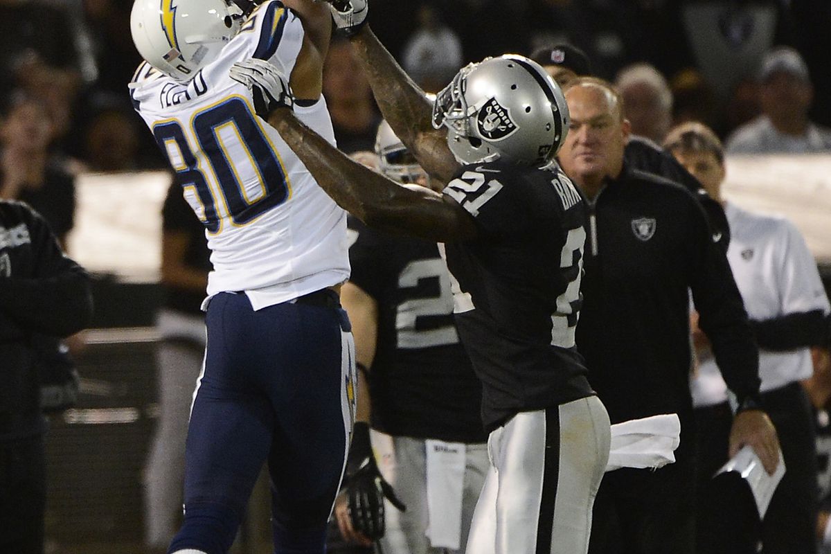 Malcom Floyd #80 of the San Diego Chargers catches a twenty three yard pass over Ron Bartell #21 of the Oakland Raiders in the second quarter of the season opener