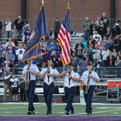 Lehi high school military auxiliary presents the flag before the game. 