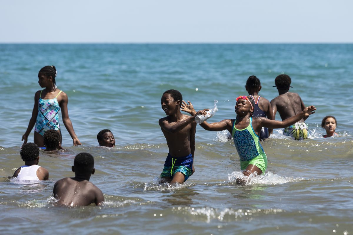 Kids play in Lake Michigan for a summer camp.