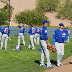 Cubs pitchers warm up before fielding drills -