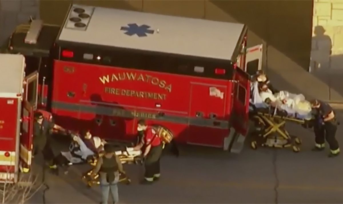In this image taken from video provided by WISN-TV, emergency crews place two people in waiting ambulances at the Mayfair Mall in Wauwatosa, Wis., on Friday.