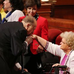 Following the Sunday morning session President Thomas S. Monson bends down and kisses sister Barbara Ballard's hand as LDS members gather for the 186th annual general conference of The Church of Jesus Christ of Latter-day Saints in Salt Lake City at the Conference Center Sunday, April 3, 2016.