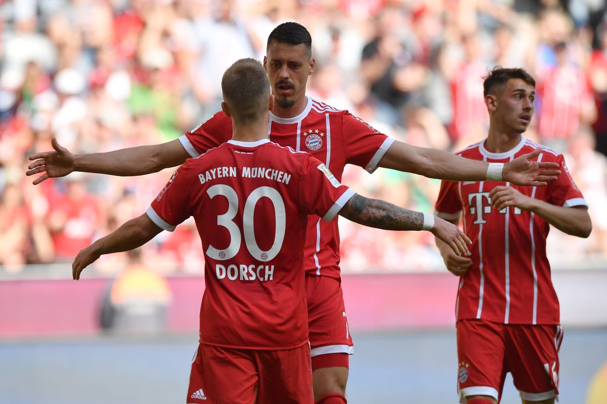 MUNICH, GERMANY - APRIL 28: Niklas Dorsch of Bayern Muenchen celebrates with teammate Sandro Wagner scoring his teams first goal during the Bundesliga match between FC Bayern Muenchen and Eintracht Frankfurt at Allianz Arena on April 28, 2018 in Munich, Germany.