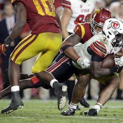 Utah quarterback Tyler Huntley is tackled by Southern California linebacker Palaie Gaoteote IV, back, during the second half of an NCAA college football game Friday, Sept. 20, 2019, in Los Angeles. 