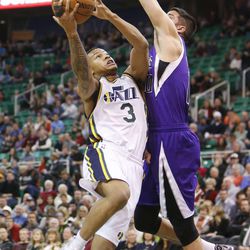 Utah Jazz point guard Trey Burke (3) drives on Sacramento Kings point guard Greivis Vasquez (10)  during NBA action in Salt Lake City  Saturday, Dec. 7, 2013. 
