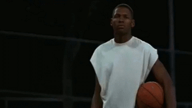 Ray Allen holding a basketball with his white shirt blowing in the wind