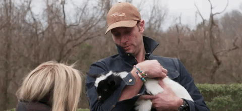 GIF of a baby goat squirming in Jay Cutler’s arms