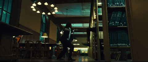 John Wick fighting Boban Marjanovic with a book in a library