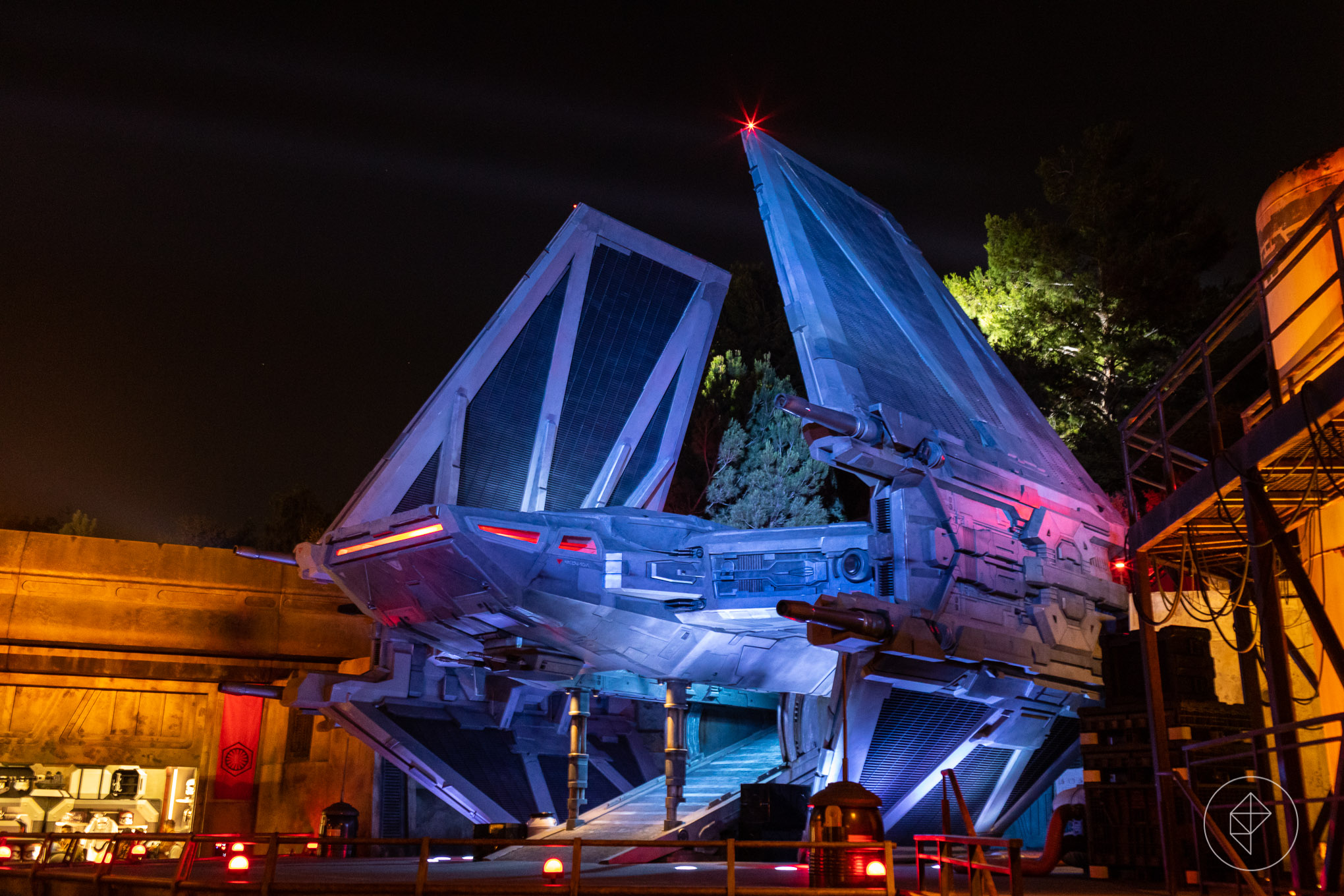 Purple lights reflect from a TIE Echelon during a special press preview of Star Wars: Galaxy’s Edge land in 2019.