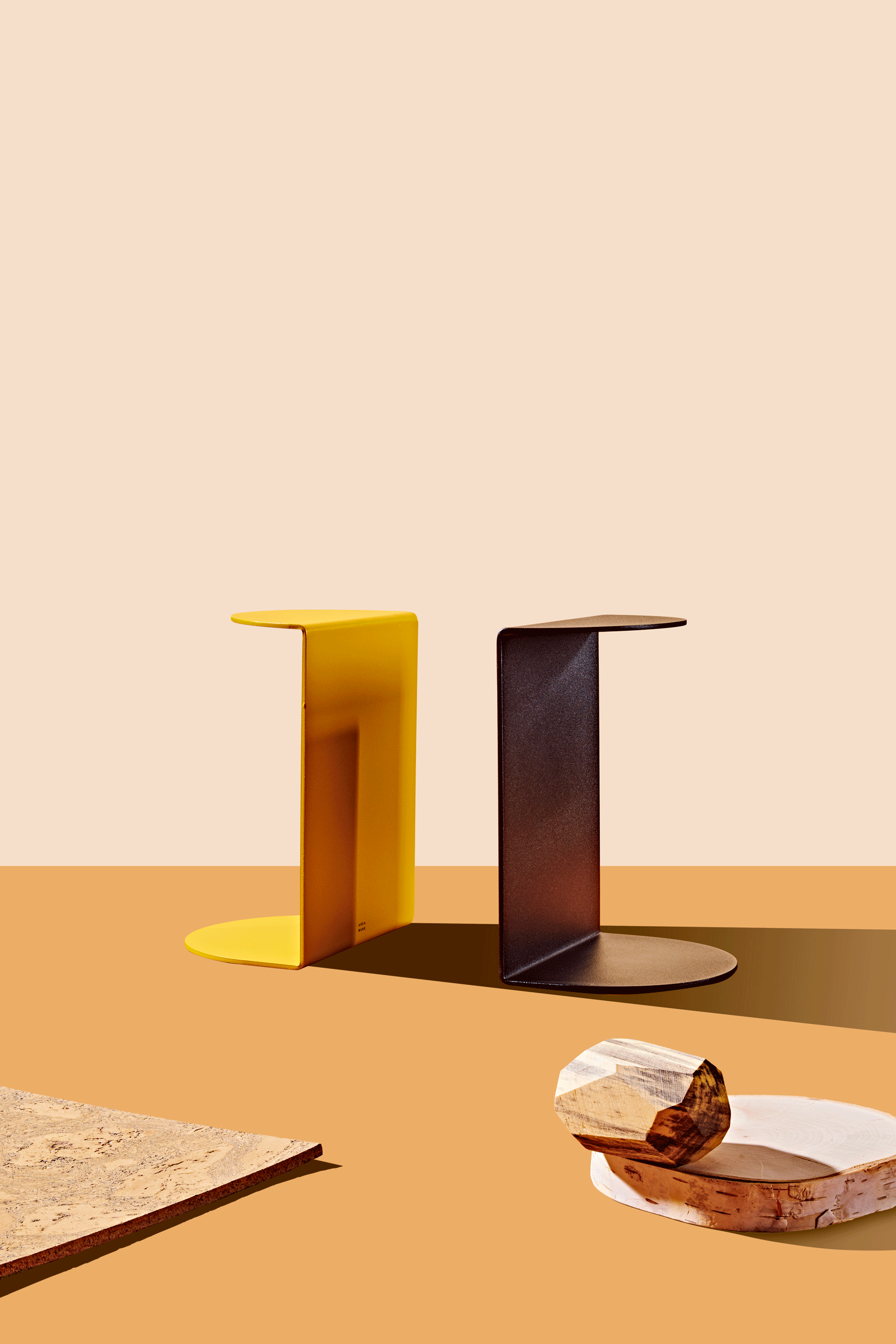 A yellow and black set of bookends sit on a flat surface while four books appear and disappear between them. These bookends are part of the Curbed Holiday Gift Guide 2019. This is an animated gif.