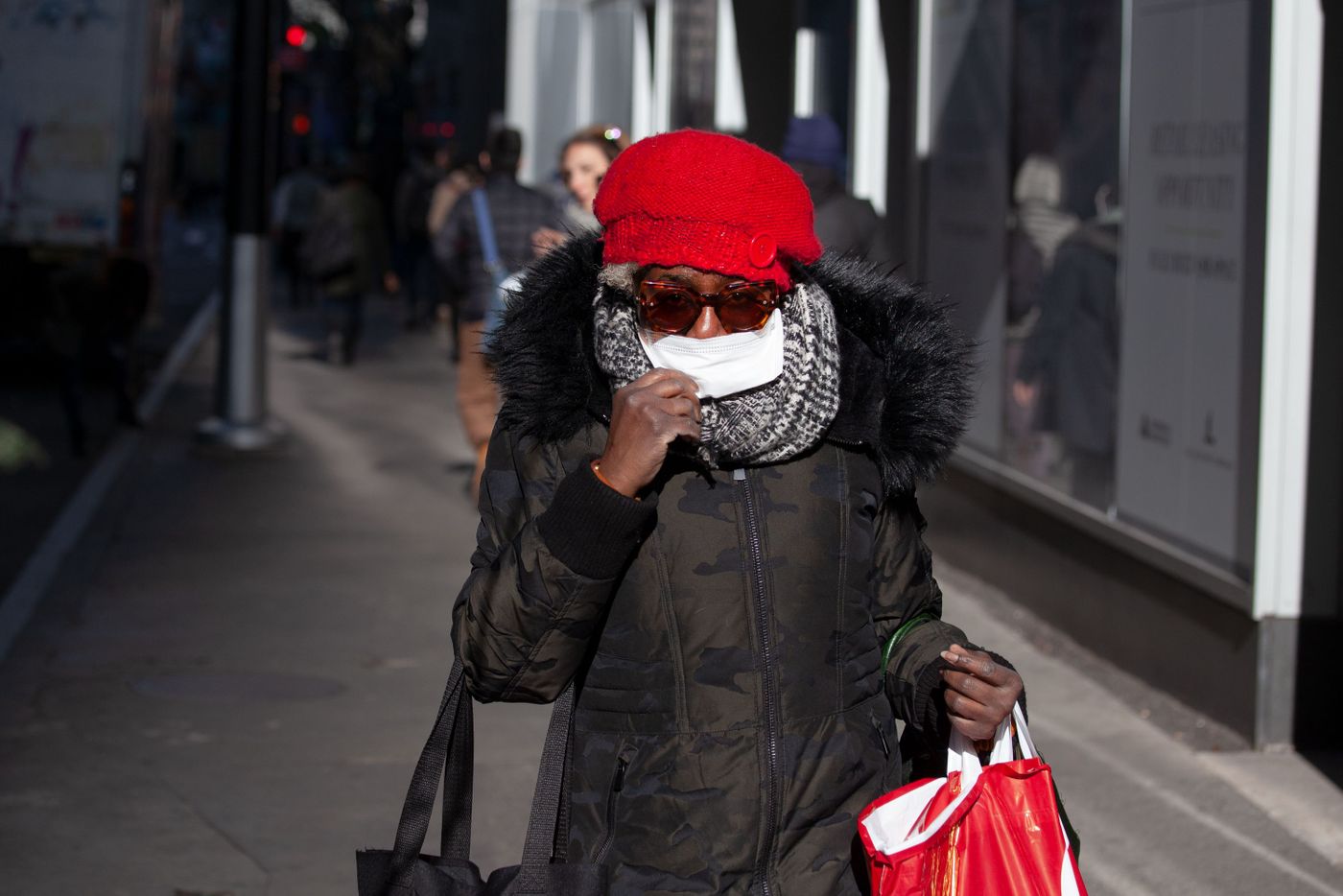 A woman in Lower Manhattan wears a surgical mask during the morning commute, March 5, 2020.