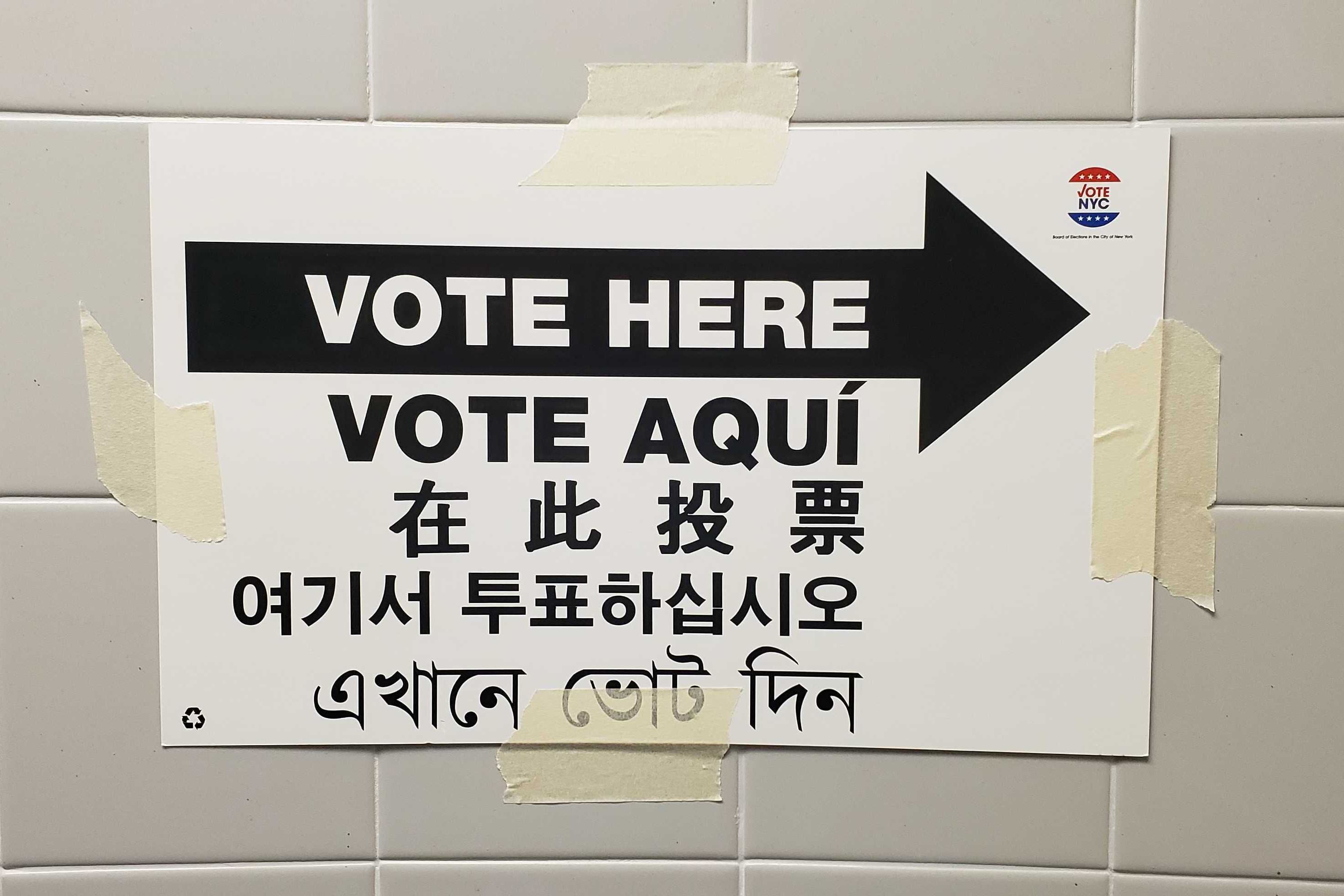 A sign directs voters toward the polling site at PS 70 in Astoria, Queens.