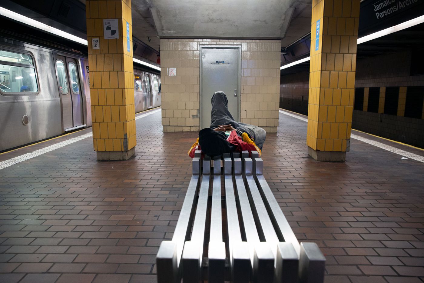A person sleeps at the Jamaica Center station, Oct. 2, 2019.