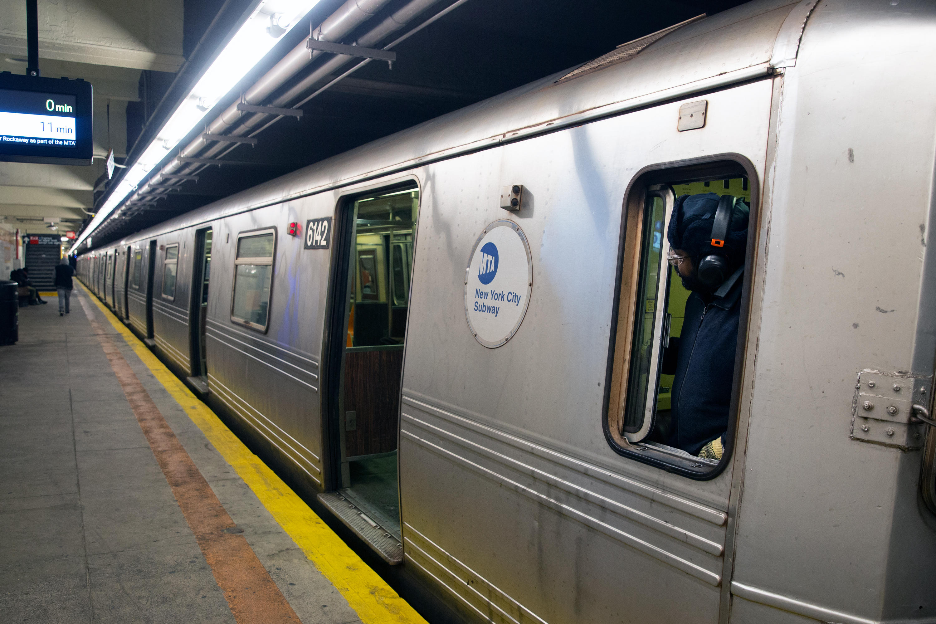 A subway conductor watches the doors of an A train in Brooklyn, April 7, 2020.