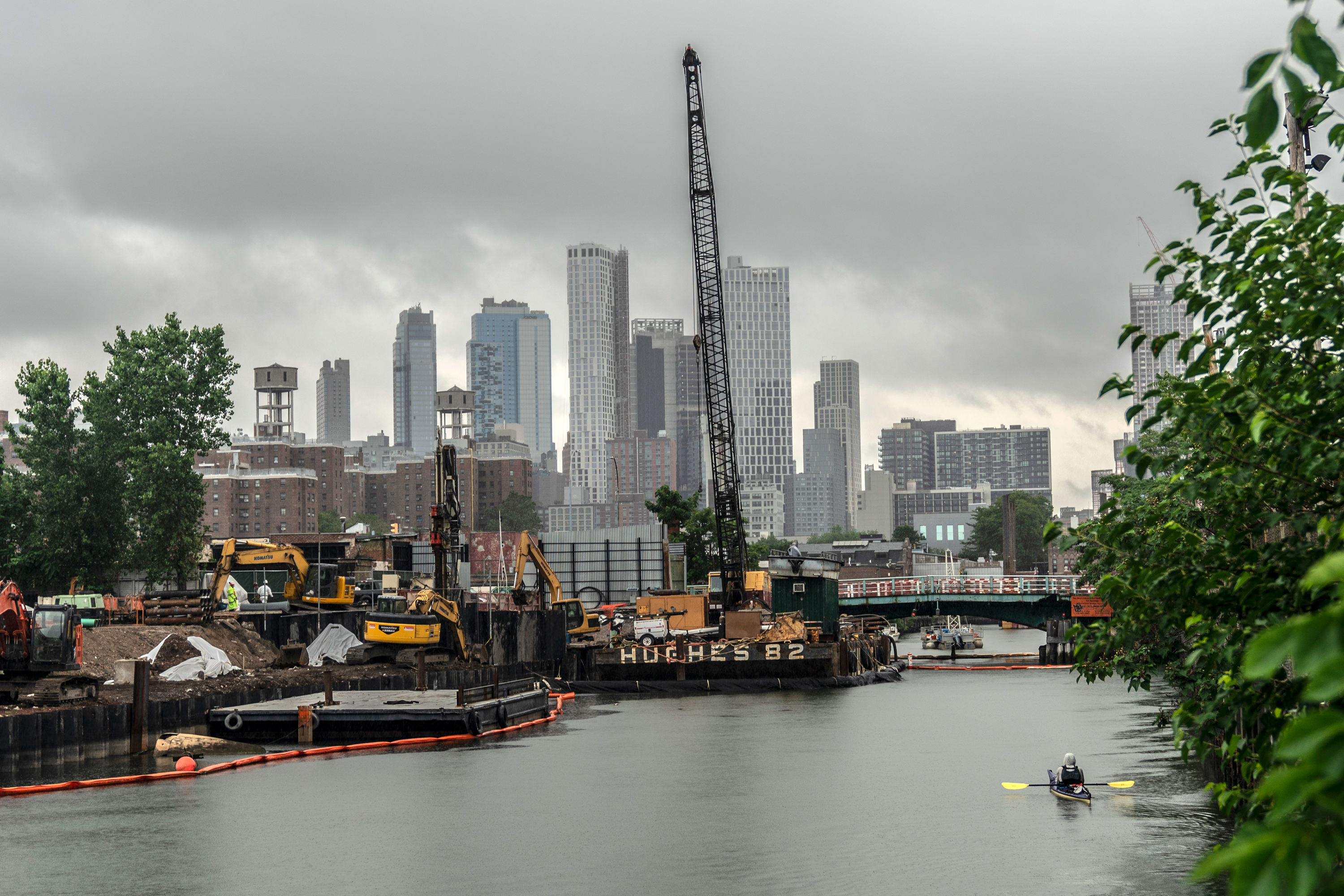 A kayaker paddles toward construction on the Gowanus Canal, July 10, 2020.