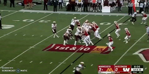 Minnesota quarterback Tanner Morgan completes a pass to Tyler Johnson for 28 yards against Wisconsin