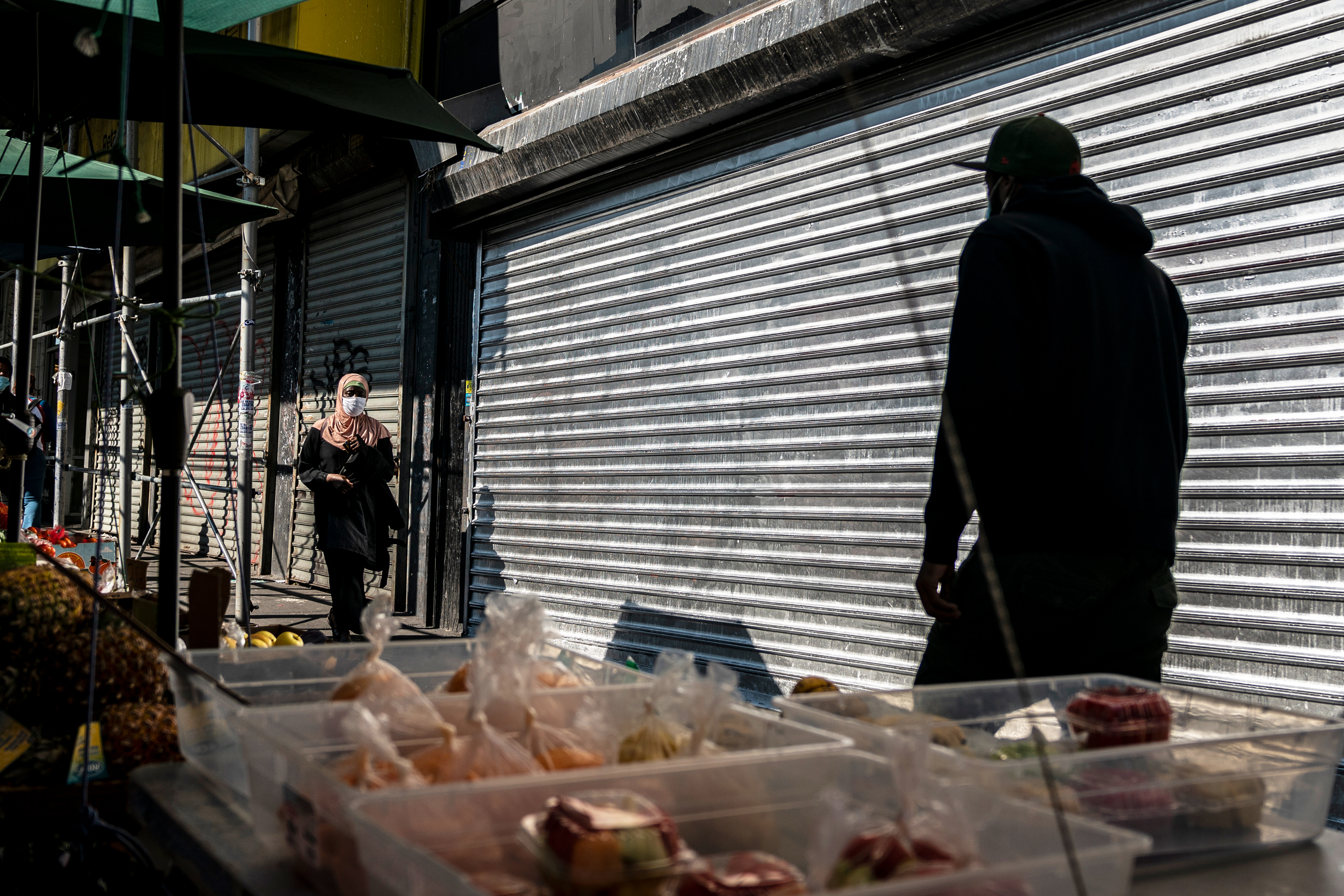 People walk by shuttered storefronts at The Hub in the South Bronx Oct. 9, 2020.