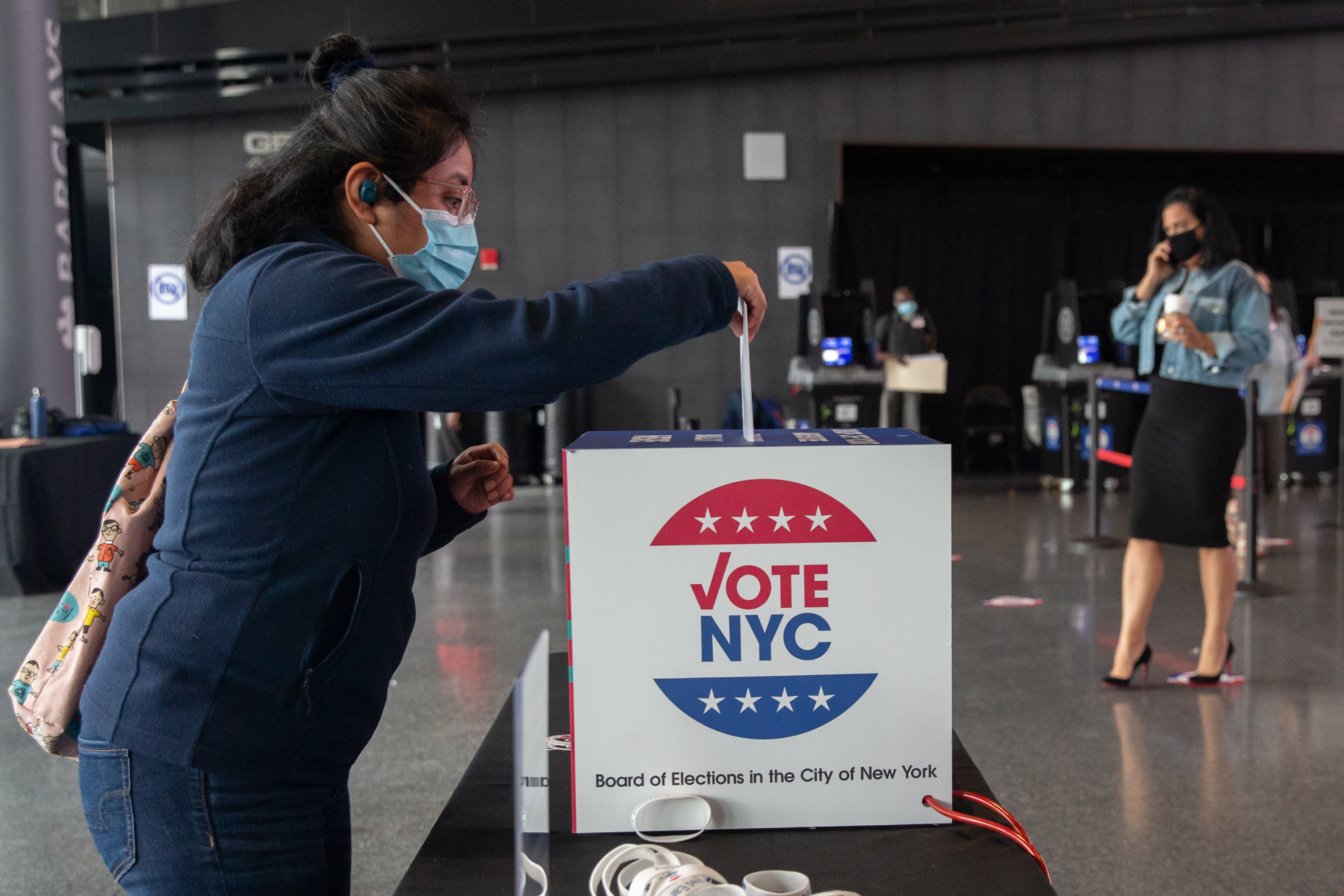 A Brooklyn resident drops off an absentee ballot at the Barclays Center on the first day of early voting, Oct. 24, 2020.