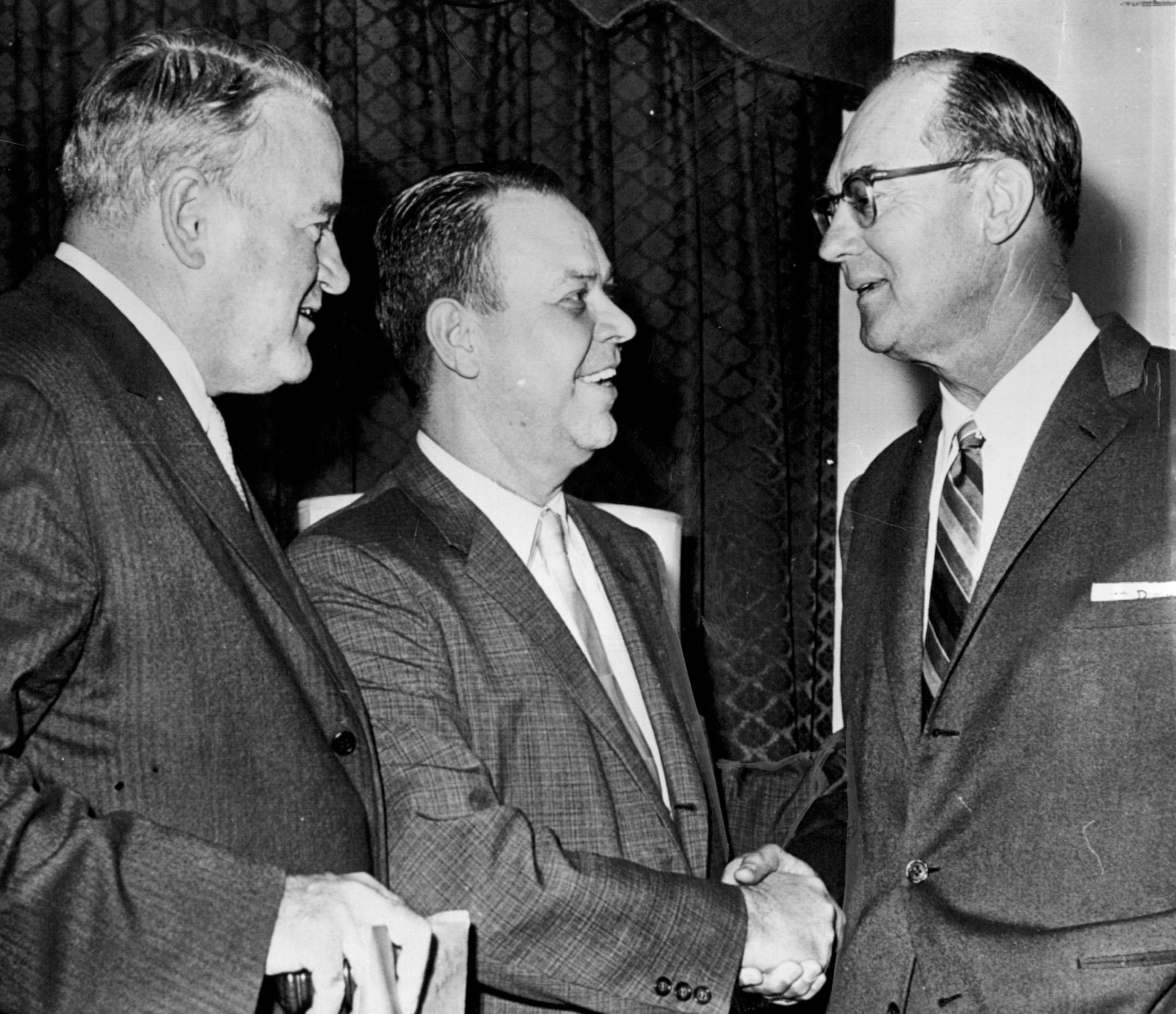 AL President Joe Cronin, left, and Yankees co-owner Del Webb, right, congratulated Calvin Griffith after the announcement that Griffith's Washington Senators were on the move to the Twin Cities.