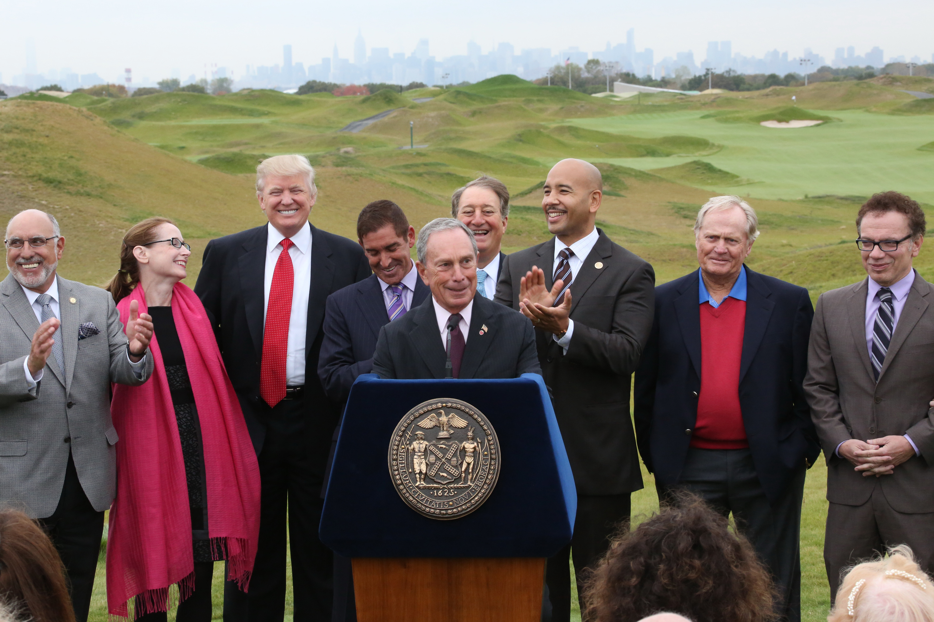 Bronx Borough President Ruben Diaz Jr., to the right of the podium, at a 2013 event announcing the opening of Trump Golf Links in Ferry Point Park, with Mayor Mike Bloomberg (center), Donald Trump and others.