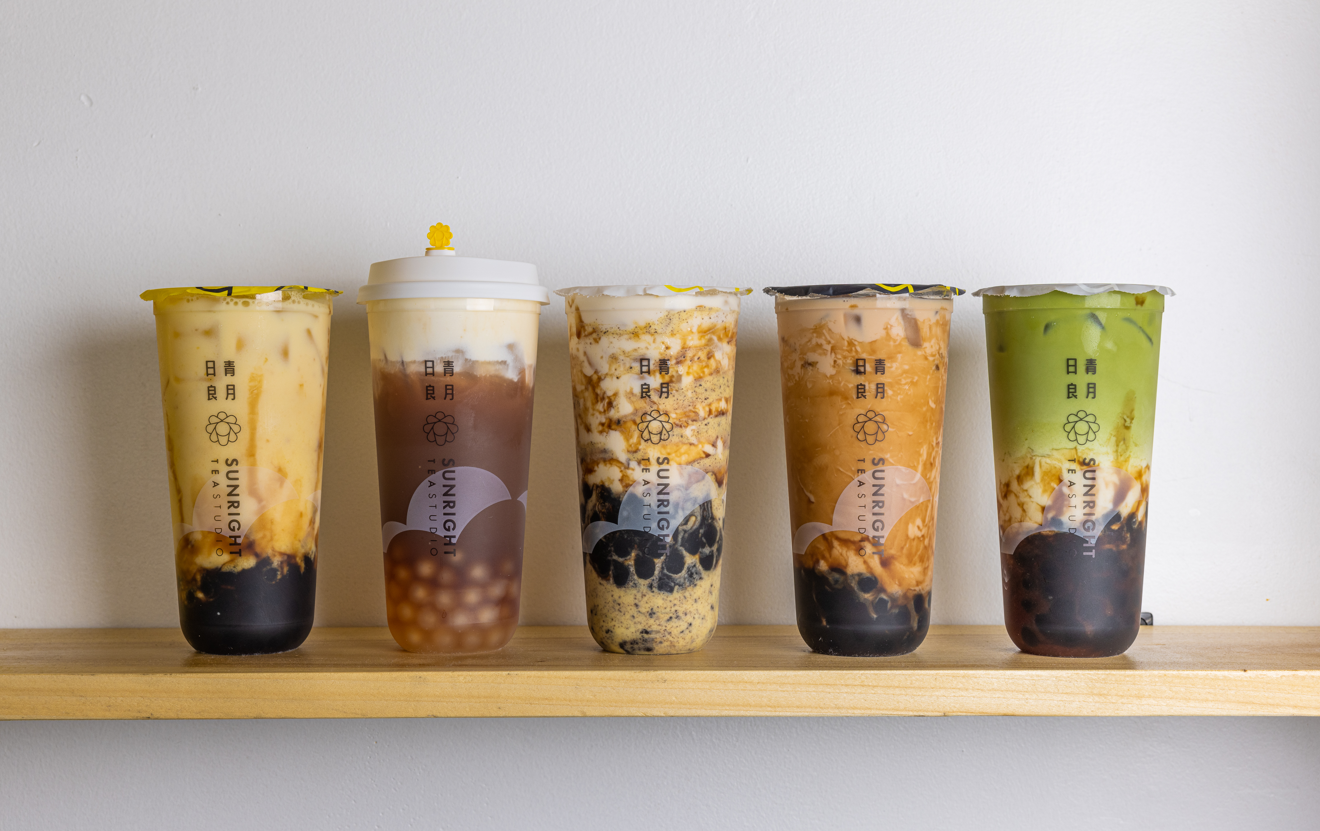 Five boba drinks with various mix-ins and toppings, ranging from green to creamy.
