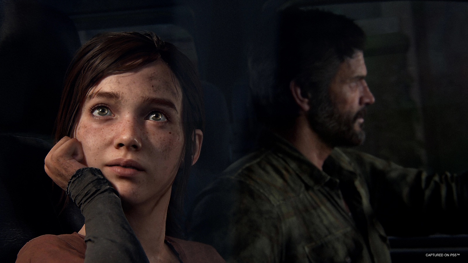 Ellie stares out a window as Joel drives in key art for The Last of Us Part 1.