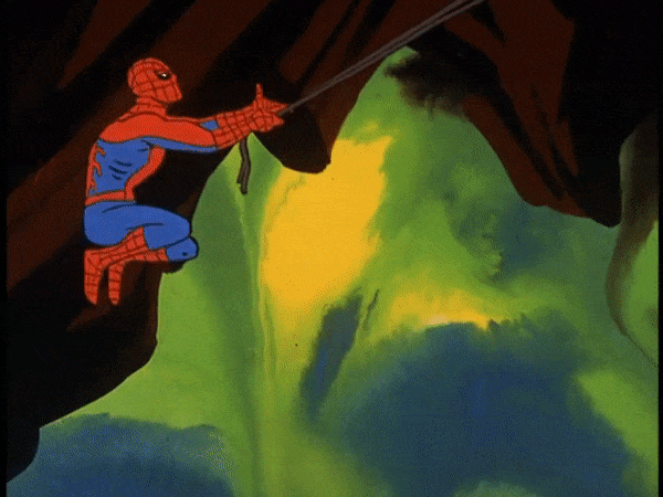Spider-Man swinging through a cave lit with green light